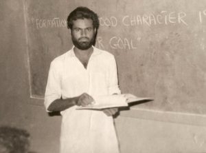 Younus AlGohar teaching a class in Karachi, Pakistan. On the board is written, ‘Formation of a good character is our goal.’